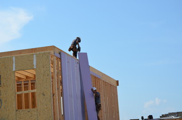 carpenter and helper framing a new house
