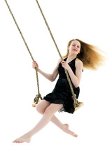 Beautiful teen school girl swinging on a swing. Concept summer v