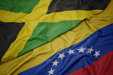 waving colorful flag of venezuela and national flag of jamaica.