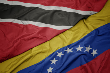 waving colorful flag of venezuela and national flag of trinidad and tobago.