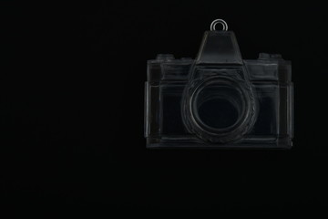 Cámara fotográfica transparente de frente en fondo negro