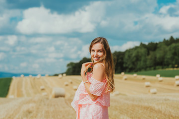 Fototapeta na wymiar Outdoor portrait of beautiful young woman in countryside