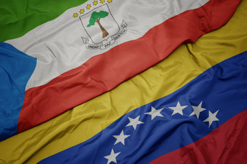 Fototapeta premium waving colorful flag of venezuela and national flag of equatorial guinea.
