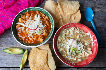 Mexican red and green pozole soup on wooden background