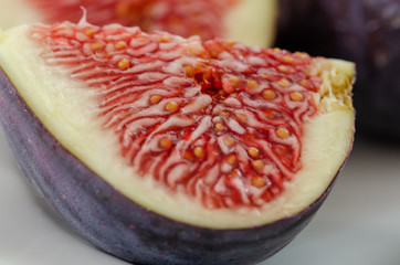 Ripe quarter fig on white background.