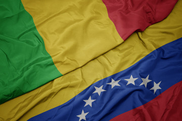 waving colorful flag of venezuela and national flag of mali.