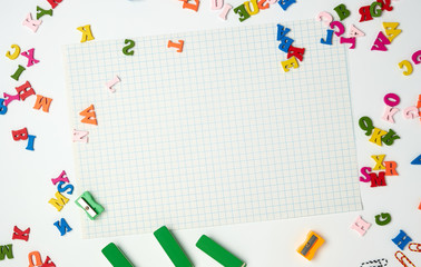 sheets in a cage and small multi-colored wooden letters