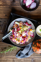 Vegetable salad with red and white chicory, baked trout pieces, onion and roasted Hokkaido squash
