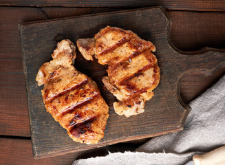 pork fried steak lies on a vintage brown wooden board