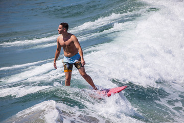 surfer iding the waves at pacific beach