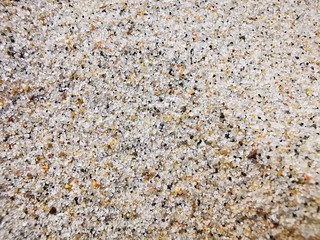 Sand texture close-up. Macrophotography. Small particles of different shades of beige, brown. Natural textured surface