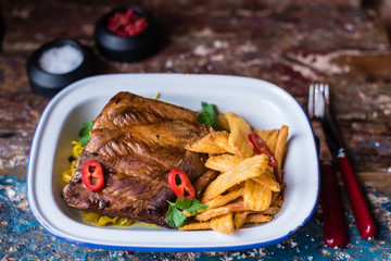 Roasted pork ribs with fried potatoes and sauerkraut