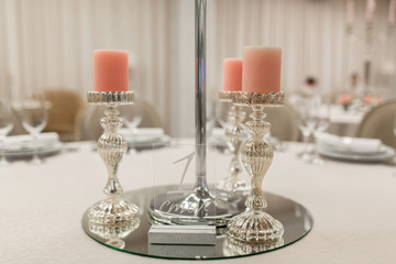 Close-up stand for a candlestick and a table number in a restaurant. Event decor