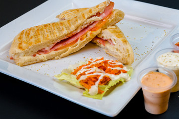 Ham sandwich with melted cheese and ketchup