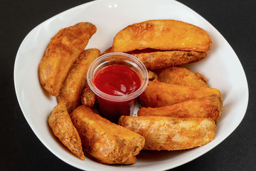 Homemade potato chips with ketchup sauce