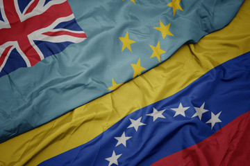 waving colorful flag of venezuela and national flag of Tuvalu .