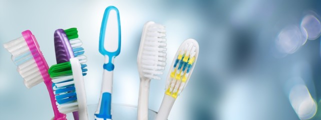 New Colorful Toothbrushes in A Glass  on  Background