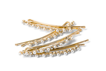 Many beautiful gold hair pins with gems on white background
