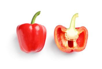 Cut and whole ripe red bell peppers on white background, top view