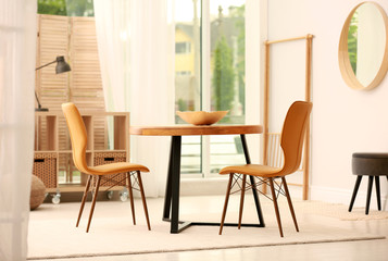 Modern dining room interior with table and chairs