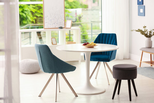 Modern dining room interior with table and chairs
