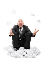 Angry businessman in depression hand throwing crumpled torn paper document