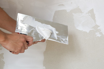 Process of plastering wall with putty-knife. Fixing wall surface and preparation for painting, home...