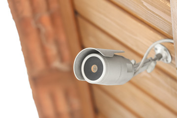 Modern CCTV security camera on building outdoors. Space for text