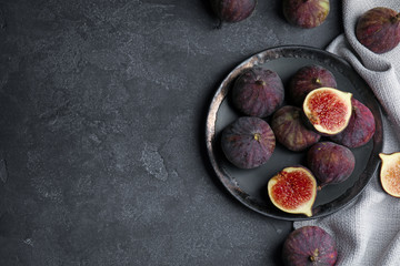 Obraz na płótnie Canvas Tasty ripe fig fruits on grey table, flat lay. Space for text