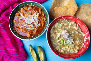 Mexican red and green pozole soup on blue background