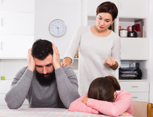 Fototapeta premium Mother lecturing husband and daughter