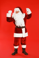 Happy authentic Santa Claus on red background