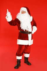 Happy authentic Santa Claus on red background