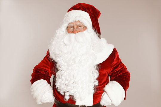 Happy authentic Santa Claus on grey background