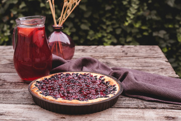 Berry pie with cherry, currant, blackberry, blueberry on wooden table in rustic style . Homemade cheesecake on the outdoor with copy space.