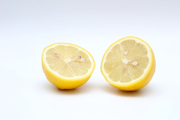 Fresh, ripe, isolated, juicy bisected lemon on a white background. Studio macro shoot