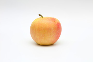 Isolated single yellow-orange-red apple on white background. Studio macro shoot