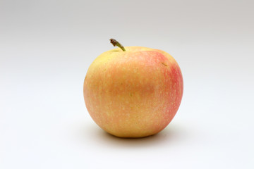 Isolated single yellow-orange-red apple on white background. Studio macro shoot