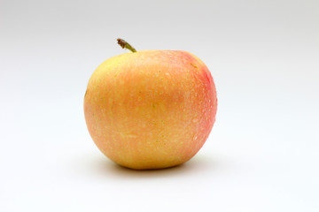 Isolated single yellow-orange-red apple on white background. Studio macro shoot