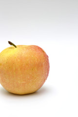 Isolated single yellow-orange-red apple on white background. Studio macro shoot