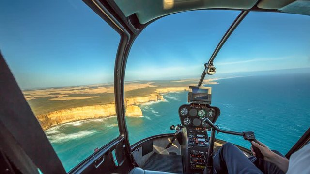 helicopter cockpit cinemagraph, during scenic flight over the Great Ocean Road in Victoria, Australia in the Port Campbell National Park flying over the Twelve Apostles and the shipwreck coast