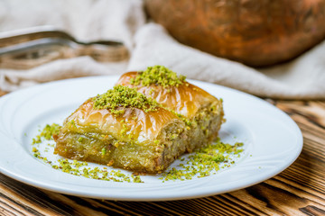 baklava durum with pistachios on wooden table. Turkish cuisine