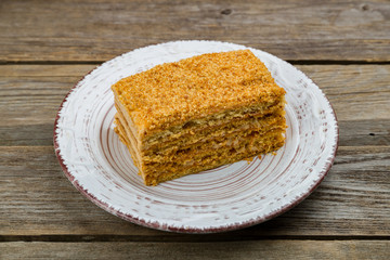 a piece of honey cake on old wooden table