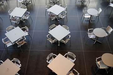 Modern style aluminum tables and chairs in a cafeteria setting seen from a high angle above