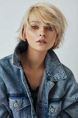 Portrait of fashion blonde woman with short hair wear denim jacket