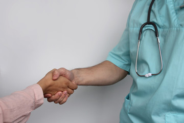 male doctor in professional medical uniform greets patient, healthcare concept, horizontal