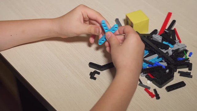 kid playing in construction set