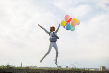 Happy young woman with balloons
