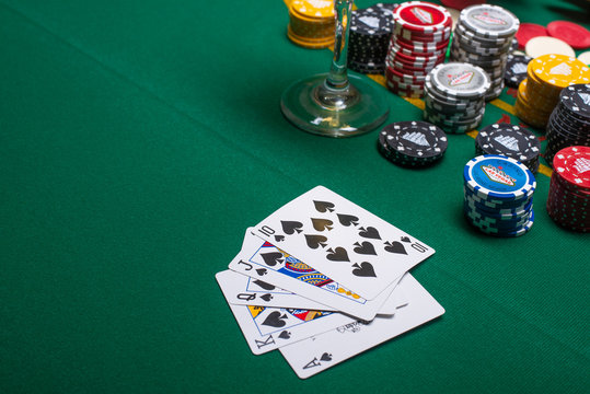 Flat lay Close-up cards for playing poker on a gaming table in a casino against a background of chips. Background for a gaming business, with space for design