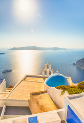 Obraz premium Romantic Picturesque View of Traditional Orthodox Blue Domed Church of Thira in Santorini. With Ferry on Background.
